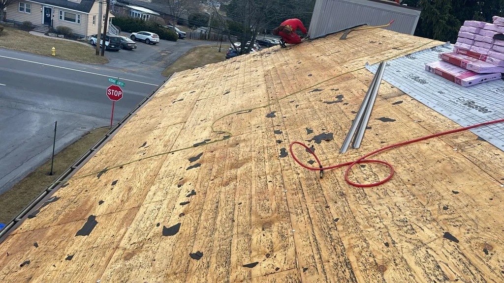 Water-stained roof deck being replaced during an emergency roof repair in Doylestown, PA